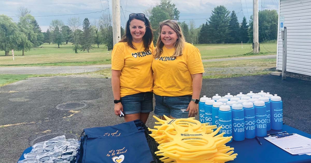 Volunteers behind sunmark booth