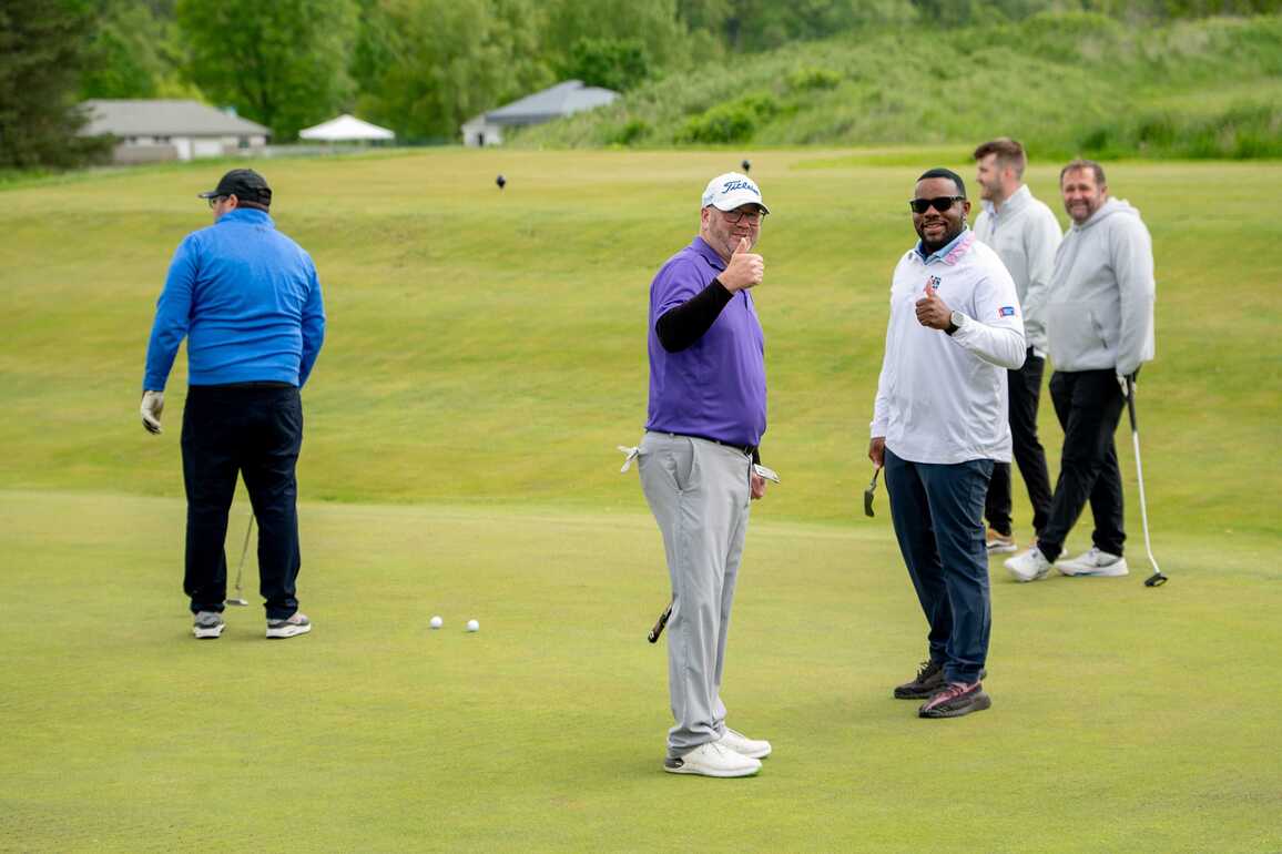 A group of golfers posing for a picture
