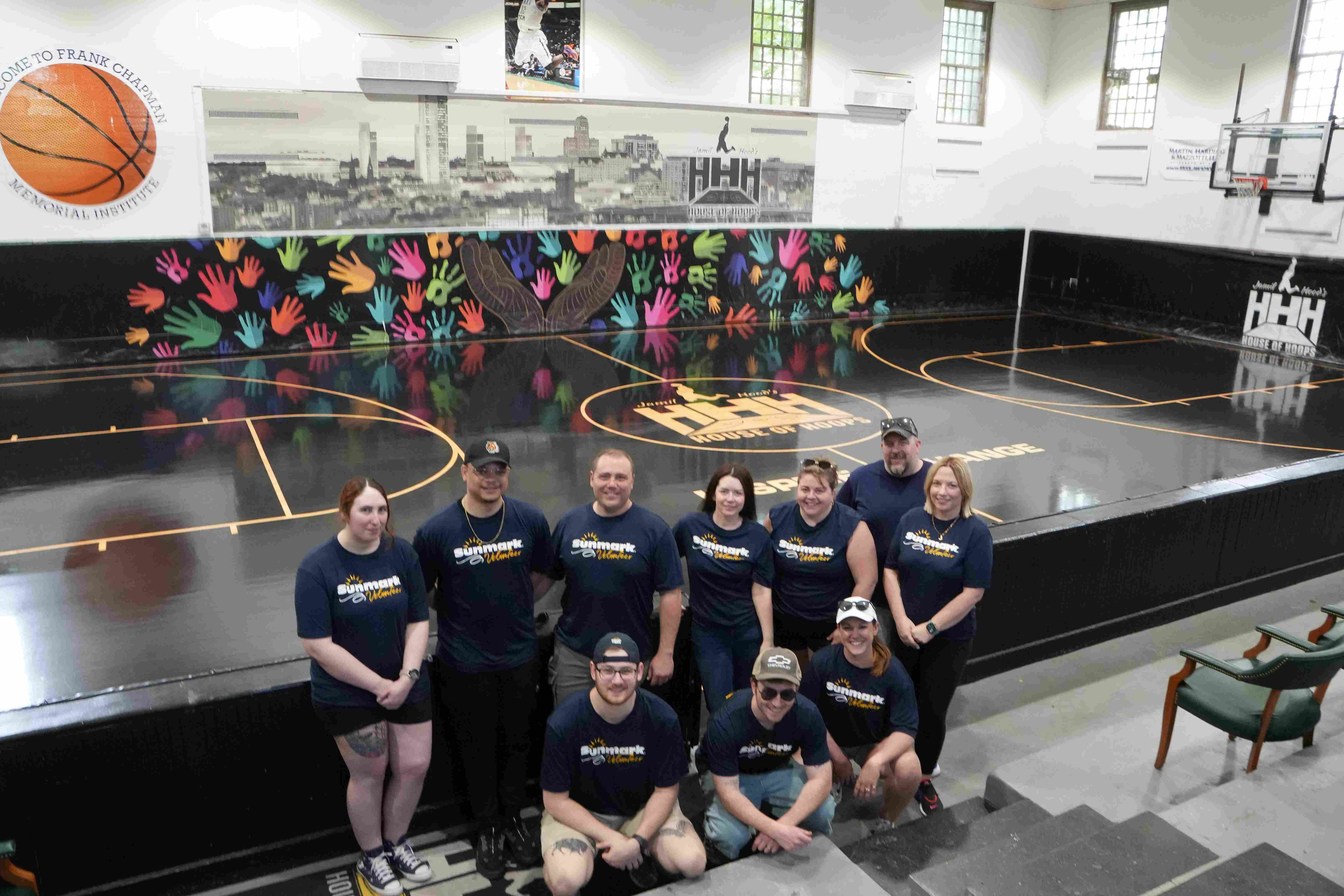 volunteers posing for a picture on a basketball court