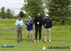 A team posing for a picture on the green