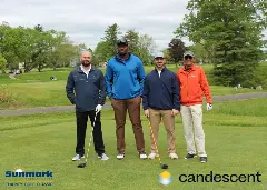 A team posing for a picture on the green