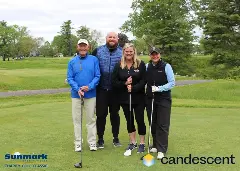 A team posing for a picture on the green
