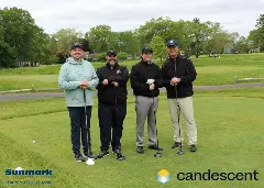 A team posing for a picture on the green