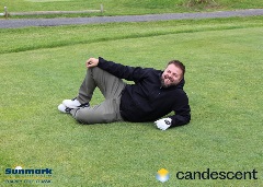 A team posing for a picture on the green