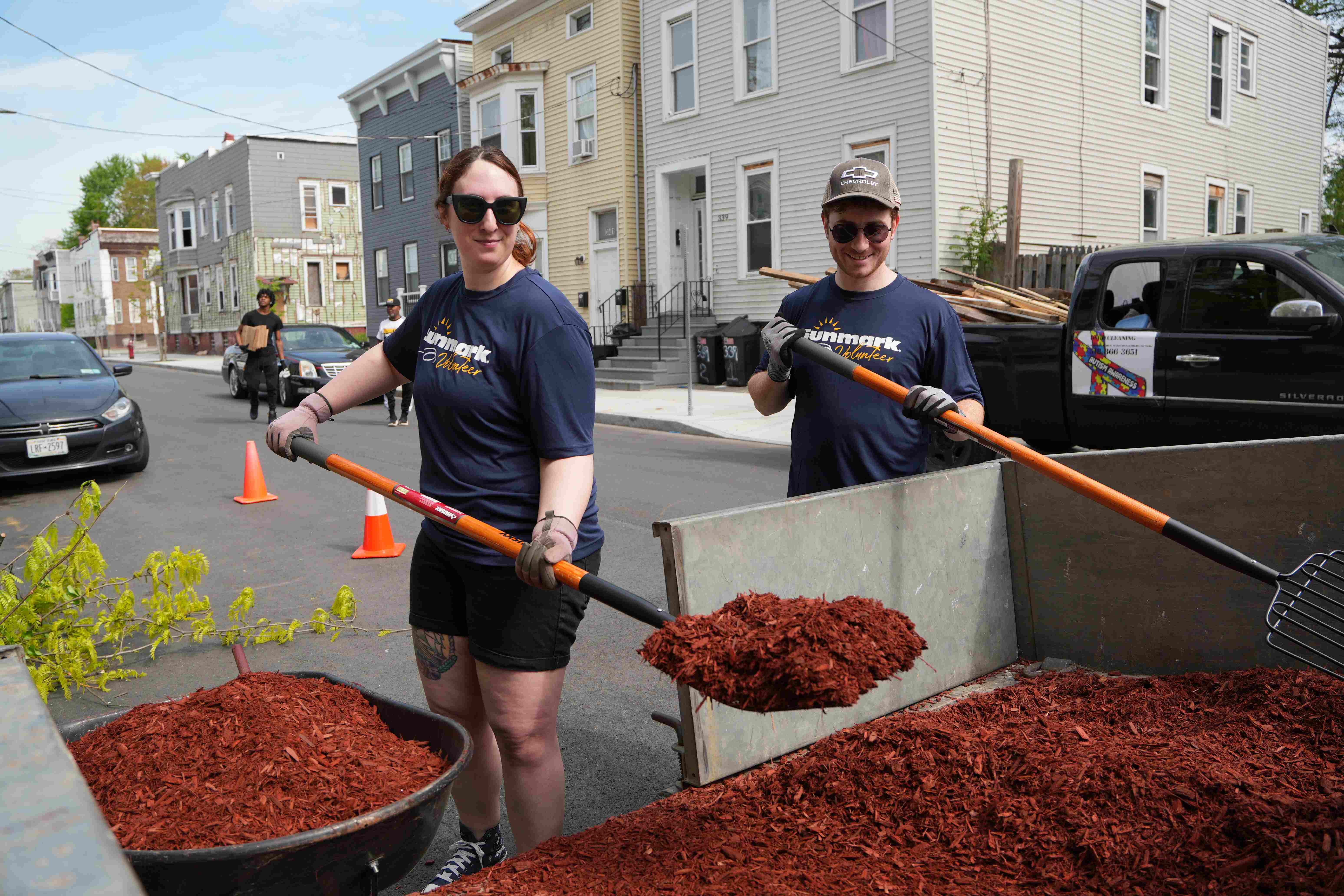 Volunteers moving mulch